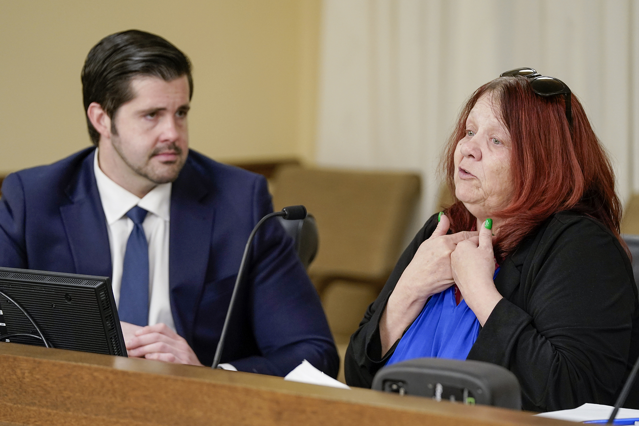 Carol LaFleur, a former client of Metropolitan Center for Independent Living, shares her story while testifying in support of HF1326 before the House workforce committee March 4. Rep. Dan Wolgamott, left, is the bill sponsor. (Photo by Michele Jokinen)