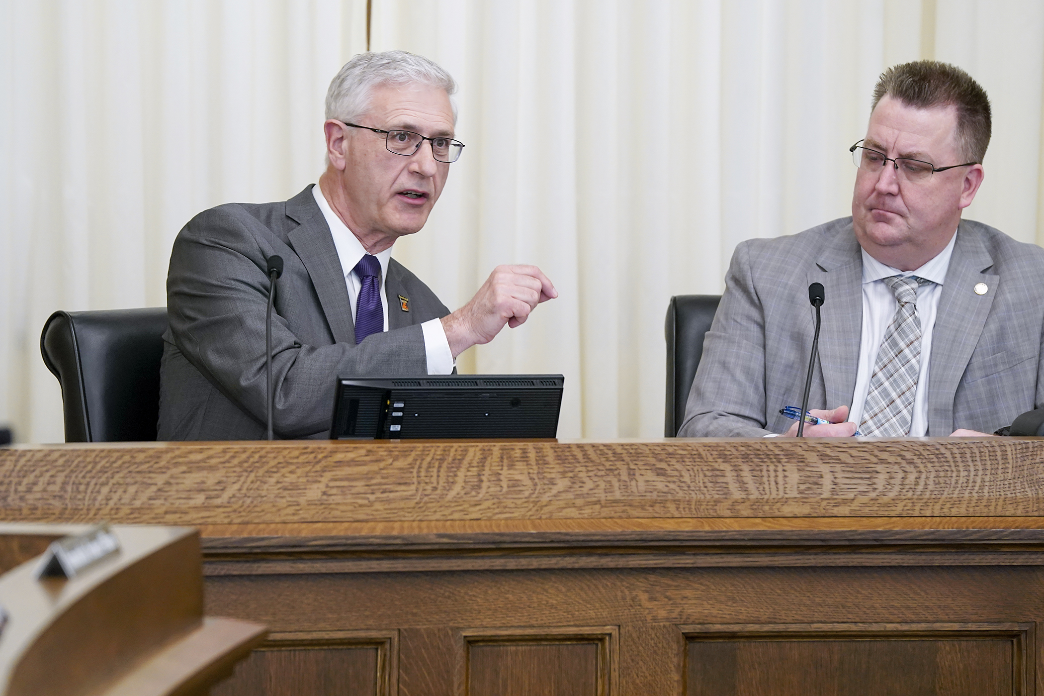 John Hausladen, president and CEO of the Minnesota Trucking Association, testifies before the House Transportation Finance and Policy Committee regarding HF1242 March 10. The bill is sponsored by Rep. Jim Joy, right. (Photo by Michele Jokinen)