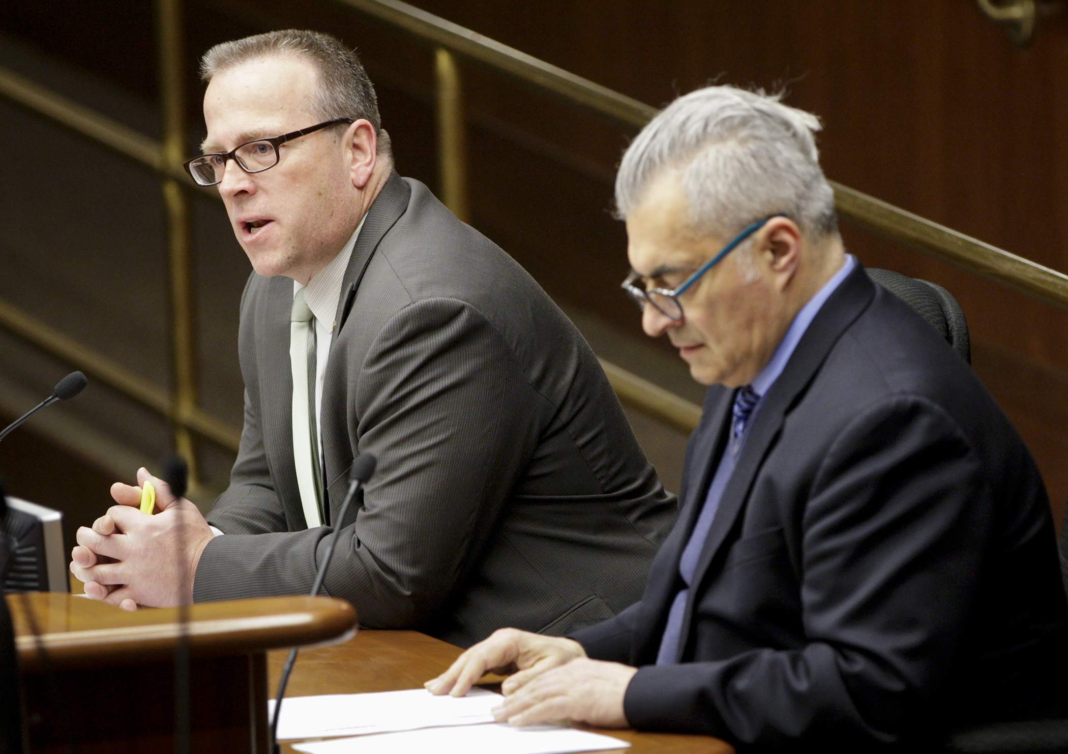 Rep. Bob Barrett, left, answers a question March 24 from a member of the House Education Innovation Policy Committee during testimony on his bill, HF2511, which would modify some provisions regarding charter schools. Photo by Paul Battaglia